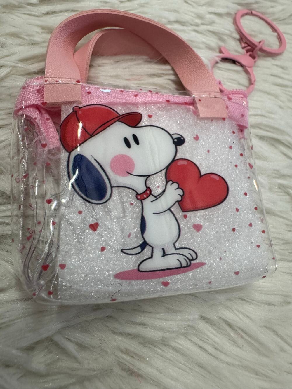 Snoopy clear mini purse keychain with pink hearts and Snoopy holding a red heart